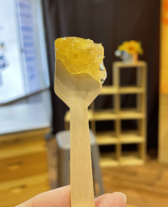 Wooden spoon with honeycomb on it